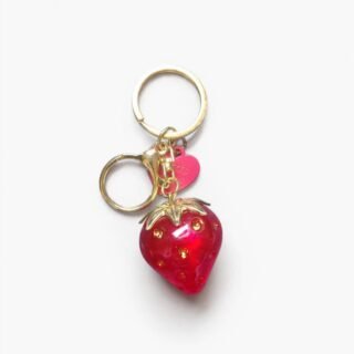 Cute strawberry-shaped keychain with a red strawberry design and green leaves, suitable for keys, bags, and backpacks.
