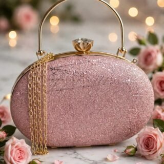Rose pink glitter clutch handbag with gold-tone arched handle, jeweled clasp, and decorative gold chain surrounded by pink roses.